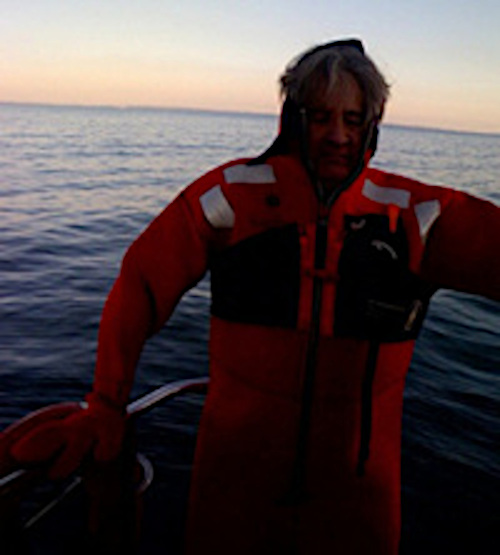 Man in wet suit on boat