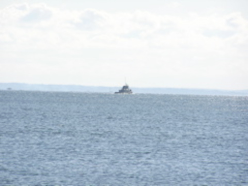 Boat in distance on water