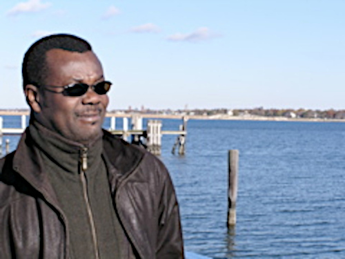 man standing next to ocean